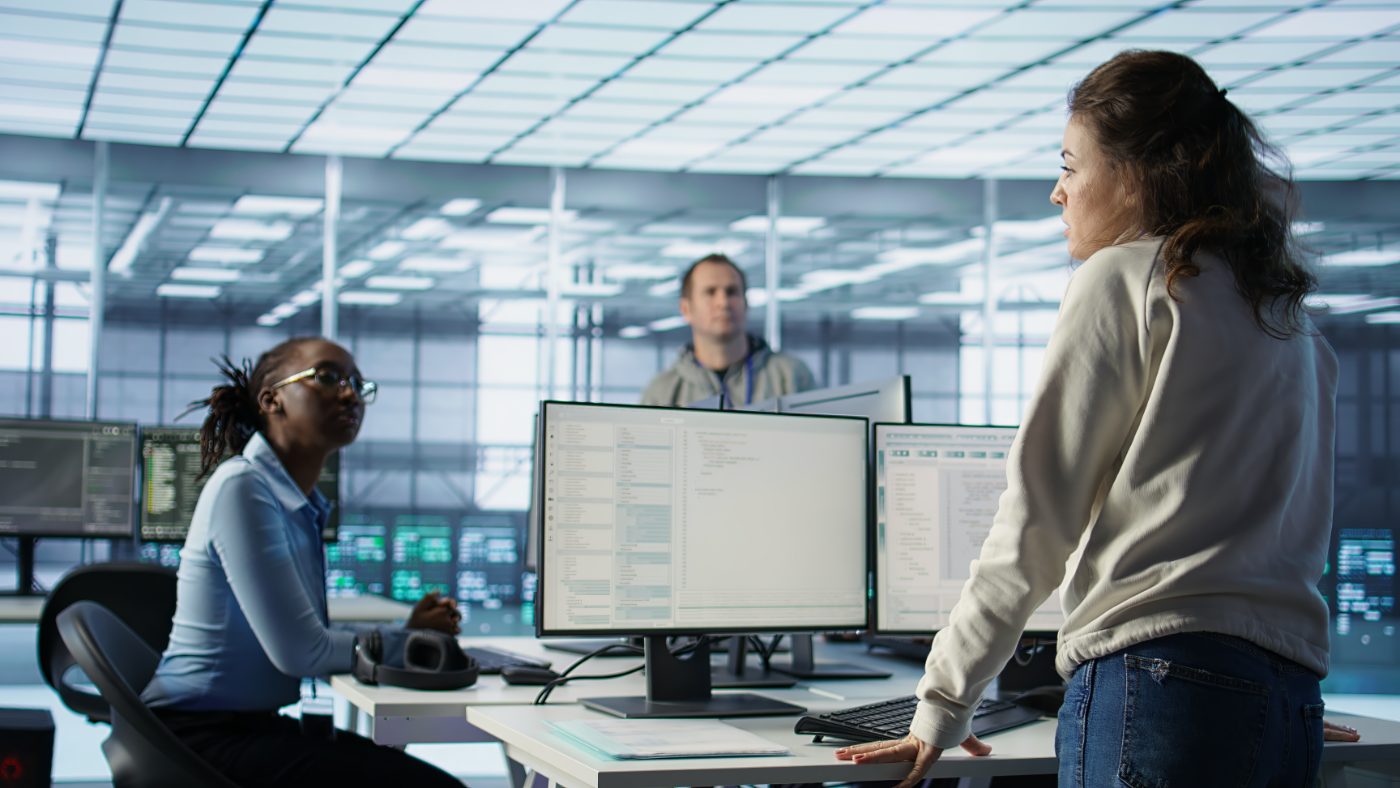 Data team reviewing systems in a control room