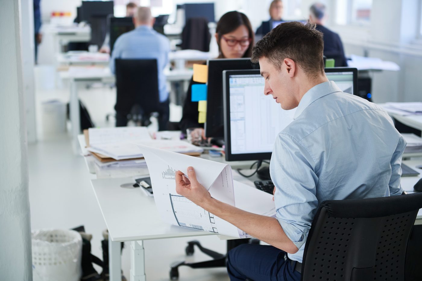Engineer reviewing a document at a desk