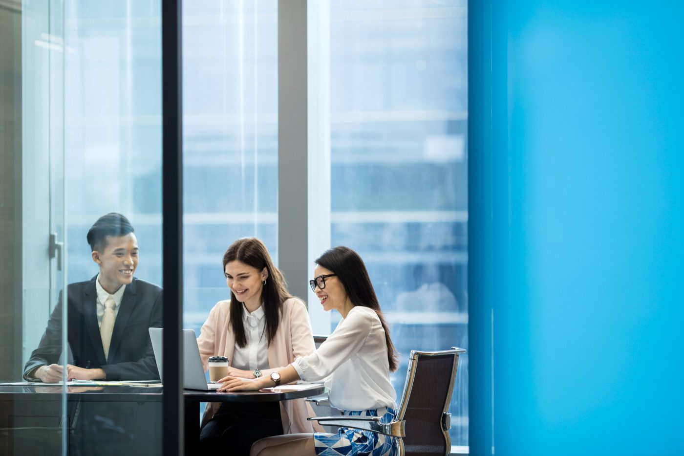 Deal team collaborating in a glass meeting room
